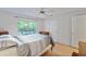 Bright bedroom featuring a ceiling fan, large window, and an adjacent closet at 2011 N Highway 17 # 1400P, Mount Pleasant, SC 29466