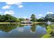 Scenic lake view featuring a clubhouse with a fountain and surrounding lush trees at 2011 N Highway 17 # 1400P, Mount Pleasant, SC 29466