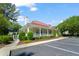 Community clubhouse showcasing a red roof, white columns, landscaping, and parking spaces at 2011 N Highway 17 # 1400P, Mount Pleasant, SC 29466
