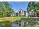 Apartments reflected in a serene pond, surrounded by lush greenery, offering a peaceful and picturesque setting at 2011 N Highway 17 # 1400P, Mount Pleasant, SC 29466