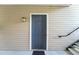 Exterior view of the front door with 'P' designation, a welcome mat, and a wall-mounted lantern at 2011 N Highway 17 # 1400P, Mount Pleasant, SC 29466