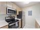 Compact kitchen with stainless steel appliances and light-colored cabinets at 2011 N Highway 17 # 1400P, Mount Pleasant, SC 29466