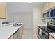 Functional kitchen featuring stainless steel appliances, light wood cabinets, and a convenient breakfast bar at 2011 N Highway 17 # 1400P, Mount Pleasant, SC 29466