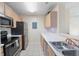 Galley kitchen featuring stainless steel appliances and light wood cabinets at 2011 N Highway 17 # 1400P, Mount Pleasant, SC 29466
