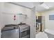 A practical laundry area with modern machines, storage shelves, and adjacent kitchen space at 2011 N Highway 17 # 1400P, Mount Pleasant, SC 29466