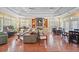 An airy living room in a community clubhouse featuring tables, chairs, and a stone fireplace at 2011 N Highway 17 # 1400P, Mount Pleasant, SC 29466