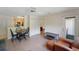 Inviting living room with light wood floors, a cozy chair, dining table with black chairs, and view into the kitchen at 2011 N Highway 17 # 1400P, Mount Pleasant, SC 29466