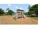 Community playground with wood chip surface, play equipment, swing set, and tennis court at 2011 N Highway 17 # 1400P, Mount Pleasant, SC 29466