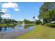 Picturesque pond view with a fountain, surrounded by lush greenery and community buildings at 2011 N Highway 17 # 1400P, Mount Pleasant, SC 29466