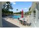 Outdoor pool area showing ample seating, umbrellas, and glimpses of surrounding community buildings at 2011 N Highway 17 # 1400P, Mount Pleasant, SC 29466