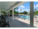 View of a community pool, framed by a covered seating area with chairs at 2011 N Highway 17 # 1400P, Mount Pleasant, SC 29466