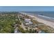 Aerial photo of an oceanfront beach, and beachfront residential and commercial buildings at 216 W Arctic Ave # 9, Folly Beach, SC 29439