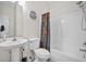 Standard bathroom with single sink and shower-tub combination with patterned shower curtain at 216 W Arctic Ave # 9, Folly Beach, SC 29439