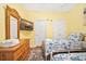 Bedroom with twin beds, tv and ceiling fan, decorated with nautical decor at 216 W Arctic Ave # 9, Folly Beach, SC 29439