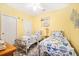 Bright bedroom featuring twin beds, ceiling fan, and nautical themed decor at 216 W Arctic Ave # 9, Folly Beach, SC 29439