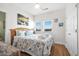 Bright bedroom features a ceiling fan, an ocean-themed decor, and hardwood floors at 216 W Arctic Ave # 9, Folly Beach, SC 29439