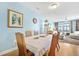 Comfortable dining area with hardwood floors, ocean view, adjacent to the living room at 216 W Arctic Ave # 9, Folly Beach, SC 29439
