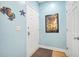 Inviting entryway with coastal decor, a neutral rug, and light-blue colored walls at 216 W Arctic Ave # 9, Folly Beach, SC 29439