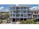 Multi-story condo building with balconies and covered parking spaces below at 216 W Arctic Ave # 9, Folly Beach, SC 29439