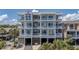 Multi-story condo building with balconies and covered parking spaces below at 216 W Arctic Ave # 9, Folly Beach, SC 29439