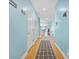 Inviting hallway with anchor-themed rug and access to bright rooms, creating a welcoming entrance to the home at 216 W Arctic Ave # 9, Folly Beach, SC 29439