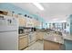 Bright kitchen featuring white appliances, marble countertops and a beautiful ocean view from the windows at 216 W Arctic Ave # 9, Folly Beach, SC 29439