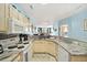 Spacious kitchen featuring white appliances, light wood cabinets and scenic ocean view at 216 W Arctic Ave # 9, Folly Beach, SC 29439