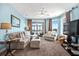 Cozy living room with comfortable seating and stunning ocean views visible through sliding glass doors at 216 W Arctic Ave # 9, Folly Beach, SC 29439