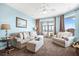 Inviting living room with plush seating and picturesque ocean views accessible via sliding glass doors at 216 W Arctic Ave # 9, Folly Beach, SC 29439