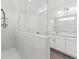 Bright, tiled walk-in shower and white marble double vanity with contemporary lighting at 2200 Hamlin Sound Cir, Mount Pleasant, SC 29466