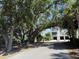Exterior angle shot of townhome featuring 2 car garage under home with mature trees at 2200 Hamlin Sound Cir, Mount Pleasant, SC 29466