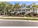 Attractive townhomes featuring a coastal design with palm trees, stairs to the front door, and nice landscaping at 2200 Hamlin Sound Cir, Mount Pleasant, SC 29466