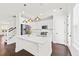 Bright kitchen boasts white cabinets, stainless steel appliances, a large island, and pendant lighting at 2200 Hamlin Sound Cir, Mount Pleasant, SC 29466