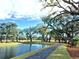 Scenic view of a pond with lush trees and a walking path creating a serene outdoor ambiance at 2200 Hamlin Sound Cir, Mount Pleasant, SC 29466