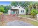 Charming single-story home with fenced yard, brick porch, and mature trees at 2350 Kent Ave, North Charleston, SC 29405