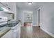 Modern kitchen featuring white cabinets, tiled floors, granite counters, and ample natural light at 2350 Kent Ave, North Charleston, SC 29405