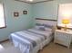 Cozy bedroom with a comfortable bed, window, and charming beach-themed decor at 2401 Palmetto Blvd, Edisto Island, SC 29438