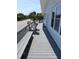 Inviting outdoor deck with built-in benches overlooking the street and scenic palm trees at 2401 Palmetto Blvd, Edisto Island, SC 29438