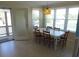 Dining room with large windows, a door to the deck, and seating for six at 2401 Palmetto Blvd, Edisto Island, SC 29438