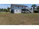 Back view of house with ground level parking and stairs leading to porch at 2401 Palmetto Blvd, Edisto Island, SC 29438