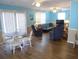 Spacious living area features wood floors, comfortable seating, and ample natural light at 2401 Palmetto Blvd, Edisto Island, SC 29438