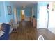 Open living area with wood-look flooring, blue walls, and a seating area for relaxing and entertaining at 2401 Palmetto Blvd, Edisto Island, SC 29438