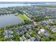 Aerial view of a residential neighborhood with a lake, mature trees, and manicured lawns at 2449 Daniel Island Dr, Daniel Island, SC 29492