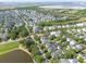 An aerial view of a neighborhood with pond and waterway in the background on a sunny day at 2449 Daniel Island Dr, Daniel Island, SC 29492