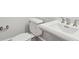 Close up on a bright bathroom featuring a white toilet and sink, and stainless steel fixtures at 2449 Daniel Island Dr, Daniel Island, SC 29492
