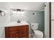 Cozy bathroom with wood vanity, a white sink, a toilet, and a shower with a sliding glass door at 2449 Daniel Island Dr, Daniel Island, SC 29492