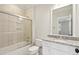 Bright bathroom with granite countertops, tiled shower with glass door and a large mirror above the vanity at 2449 Daniel Island Dr, Daniel Island, SC 29492