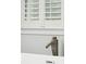 Close-up of modern bathtub faucet with window shutters, highlighting the fixture's design and natural light at 2449 Daniel Island Dr, Daniel Island, SC 29492