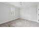 Bright bedroom with a ceiling fan, neutral carpet and trim, and natural light from the shuttered window at 2449 Daniel Island Dr, Daniel Island, SC 29492