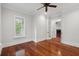 Cozy bedroom with hardwood floors, featuring French doors and a view of the fireplace and outdoor scenery at 2449 Daniel Island Dr, Daniel Island, SC 29492